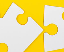 Puzzle pieces on yellow background